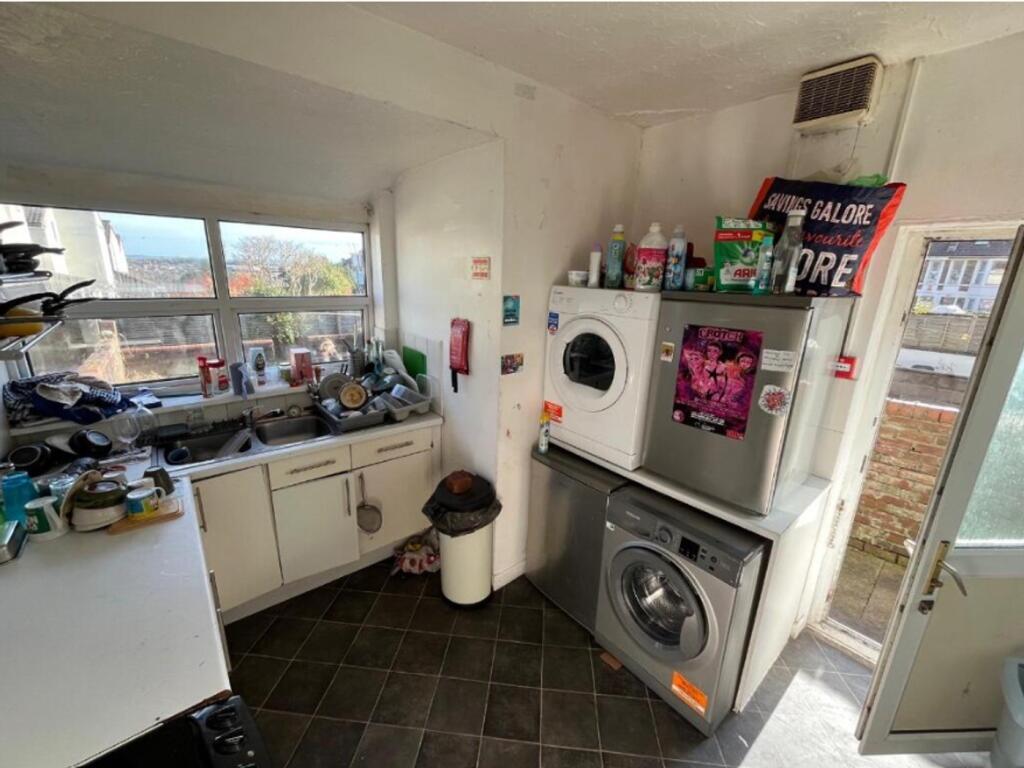 A compact kitchenette with ample natural light ...