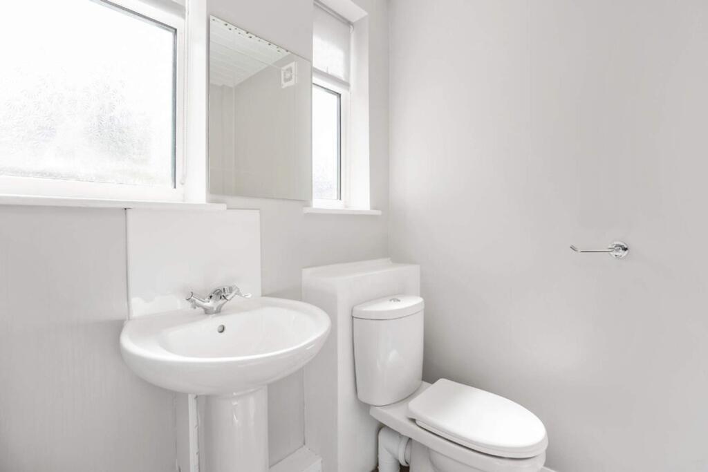 A bright and modern bathroom featuring a sleek ...