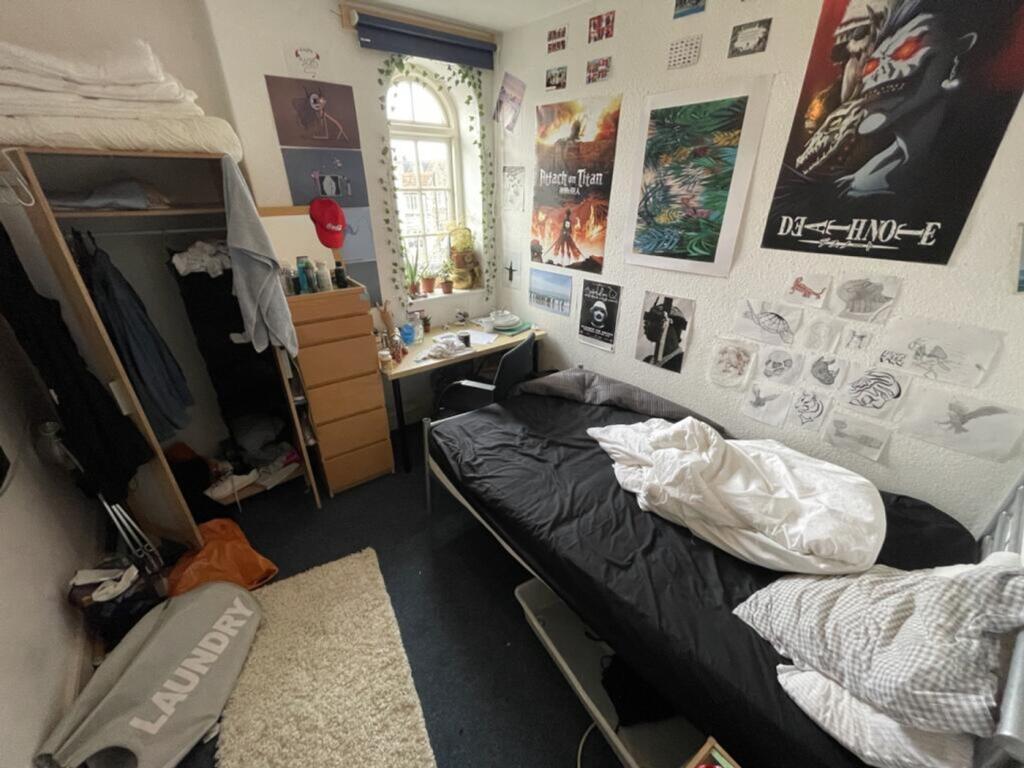 This cozy double bedroom features ample natural...