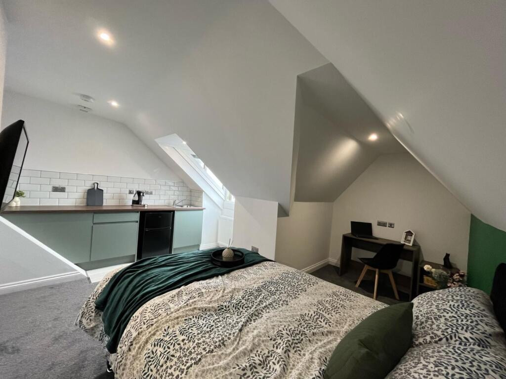 This inviting double bedroom features a cozy la...