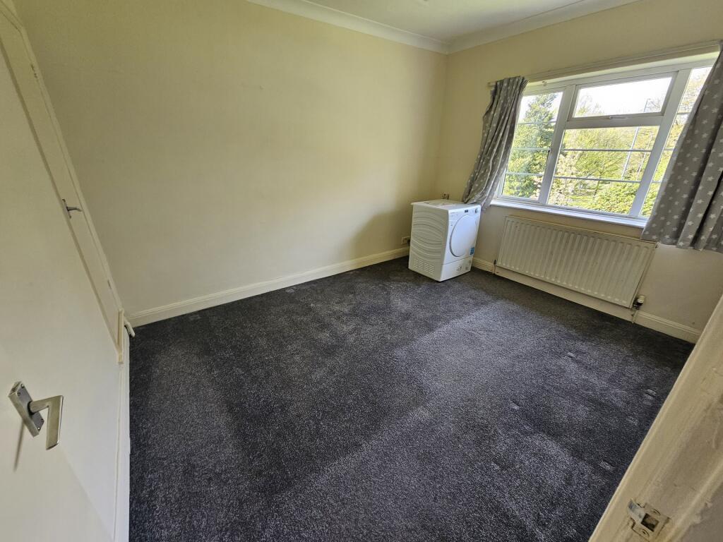 A bright and tidy double bedroom featuring a la...