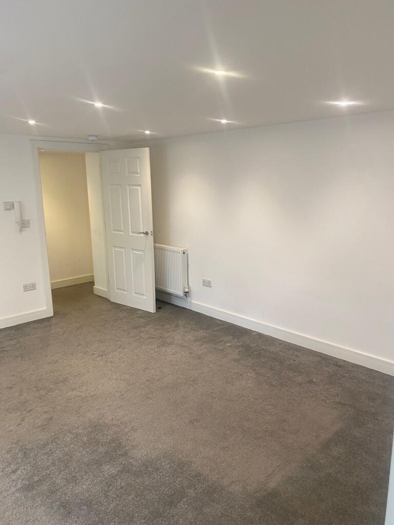 Bright, neutral living space with recessed ceil...