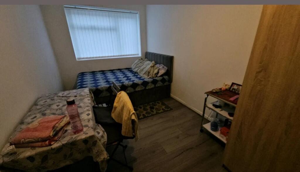 This cozy double bedroom features a comfortable...