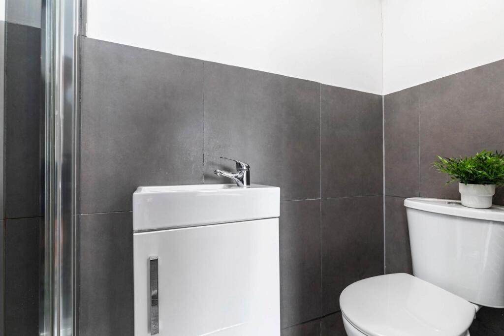 A modern bathroom featuring a sizeable bathtub ...