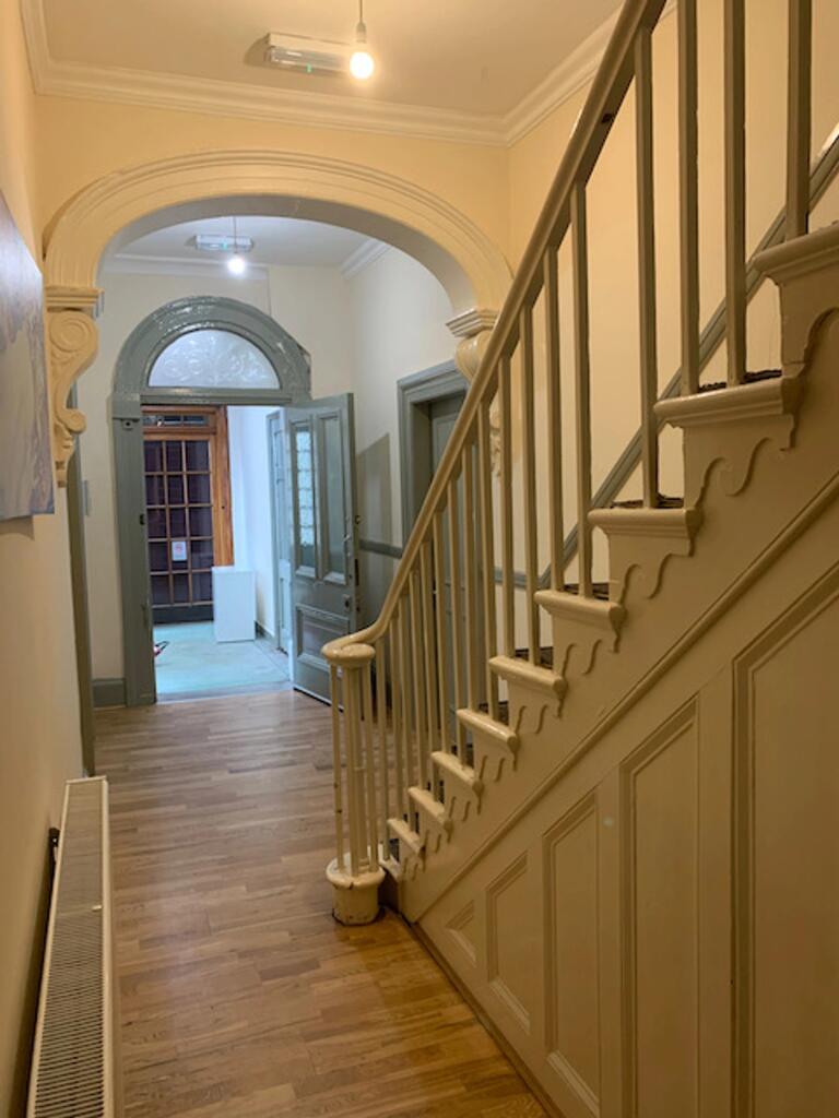 A spacious and well-maintained hallway with ele...