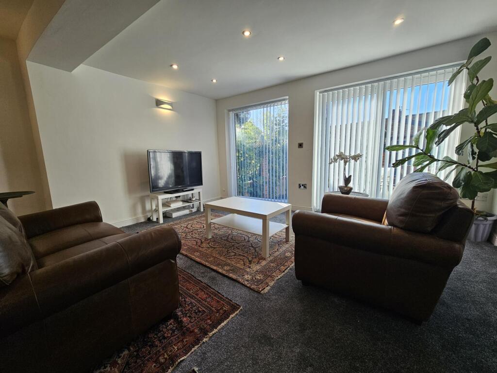 A spacious and inviting living room featuring t...