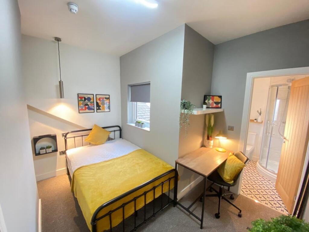 This inviting double bedroom features a cozy la...