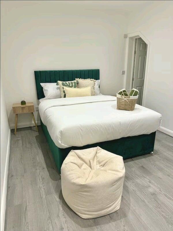 A stylish double bedroom featuring a comfortabl...