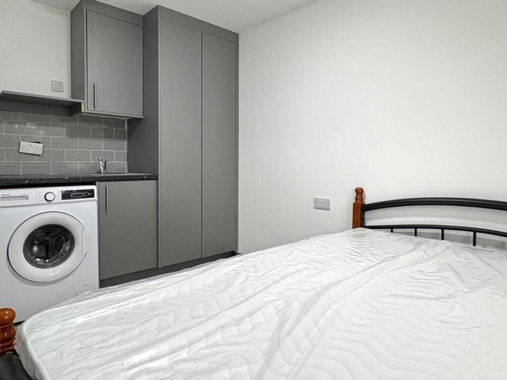 Neat bedroom with a comfortable double bed, bui...