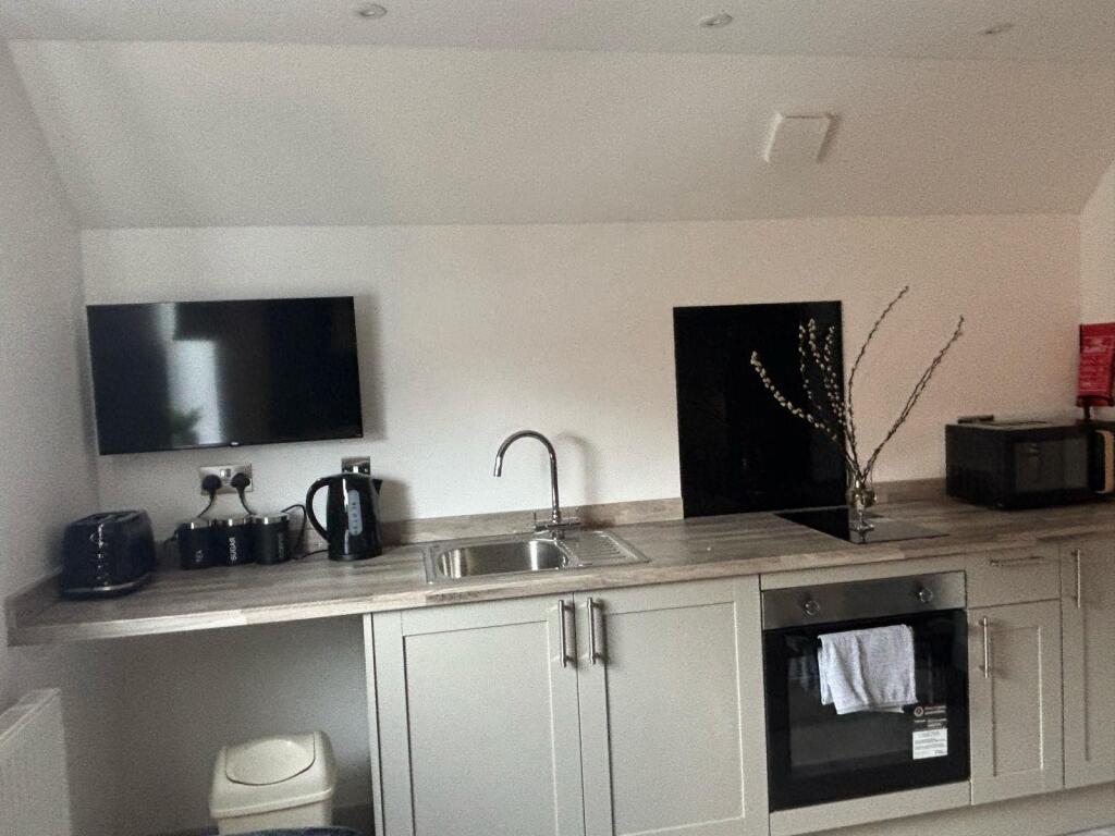 This modern kitchen features sleek cabinetry an...