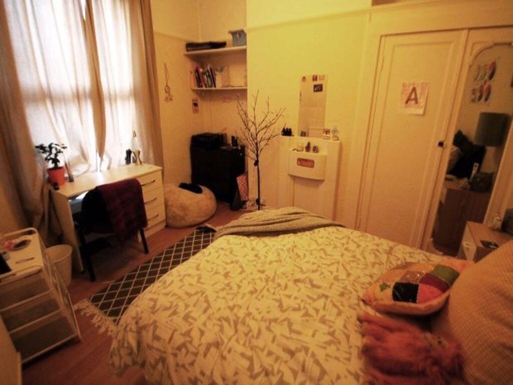 Cozy and inviting master bedroom featuring a co...