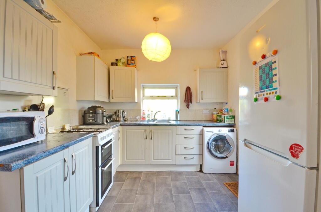 Bright and functional kitchen featuring ample w...