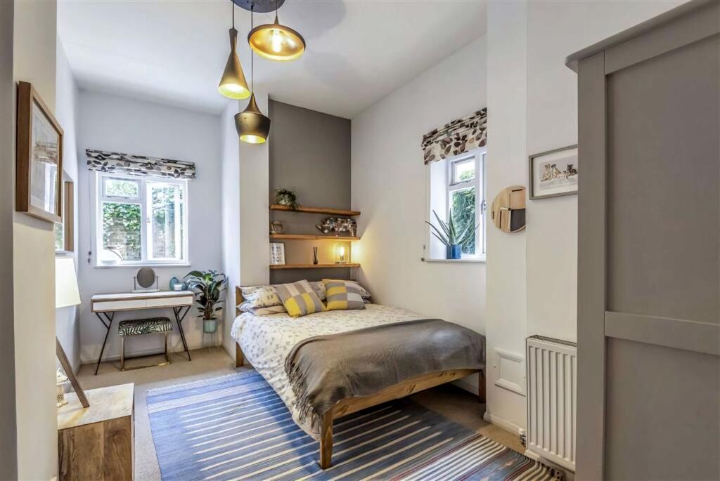 A bright and stylish double bedroom featuring t...