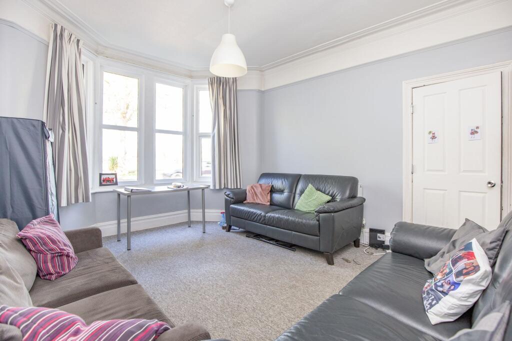 Bright and inviting living room featuring three...