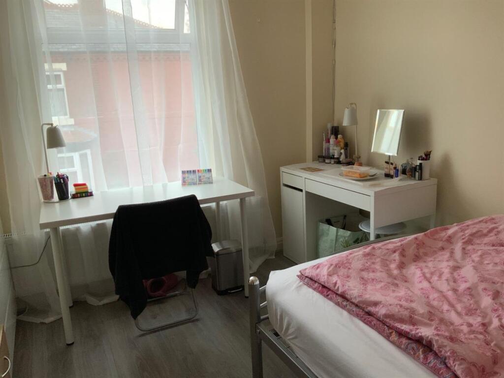 Bright single bedroom with a large front window...