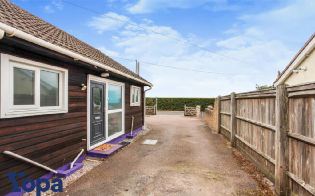 Front View Of The Property With Driveway Parking