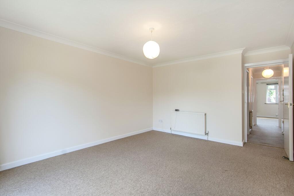 Lounge with patio doors leading to a small patio area