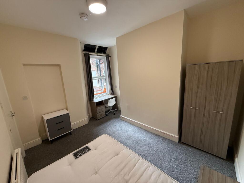 Bright, simply furnished double bedroom with a ...