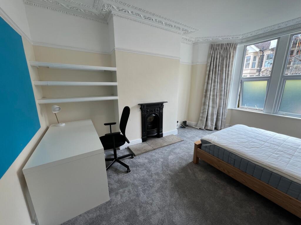 A spacious and bright double bedroom featuring ...