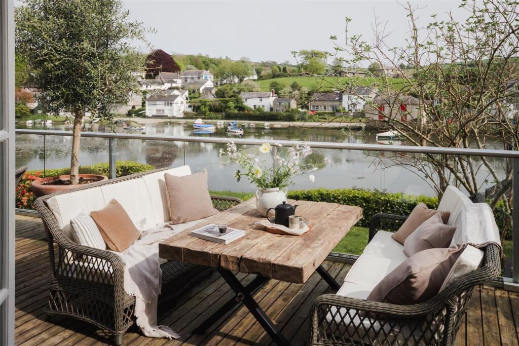 br-26 looking out doors to coffee table and river 