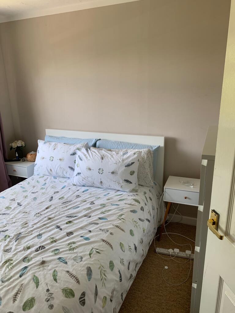A cozy and inviting double bedroom featuring a ...