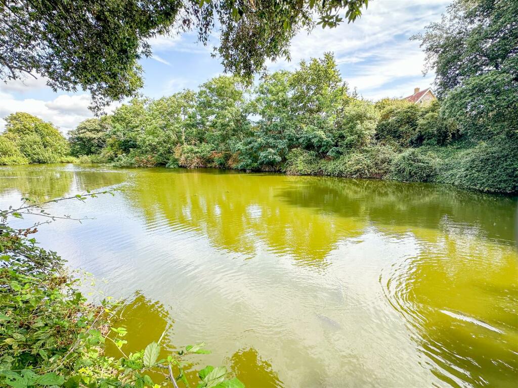 OUTSIDE REAR - COMMUNAL GROUNDS &amp; LAKE