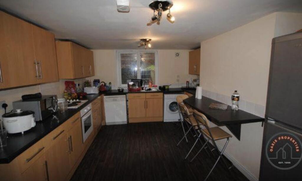 A well-equipped kitchen with ample counter spac...