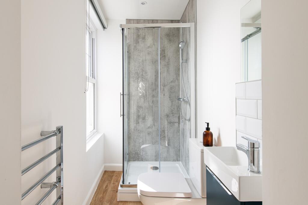 Bright and modern bathroom featuring a spacious...