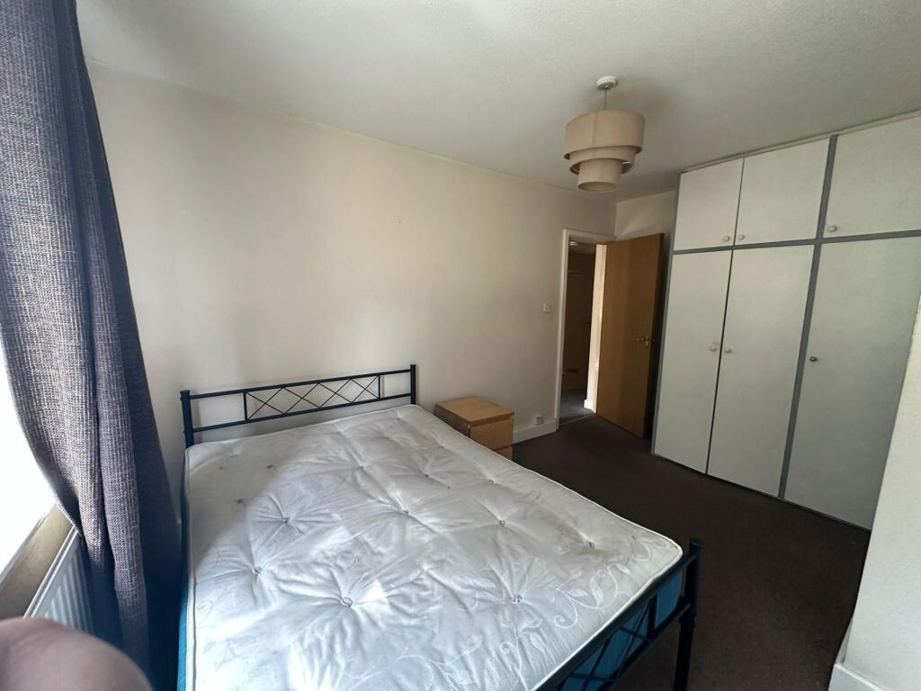 A neat double bedroom featuring a comfortable d...