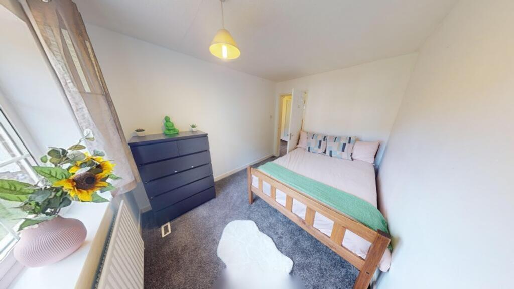 A bright and spacious double bedroom featuring ...