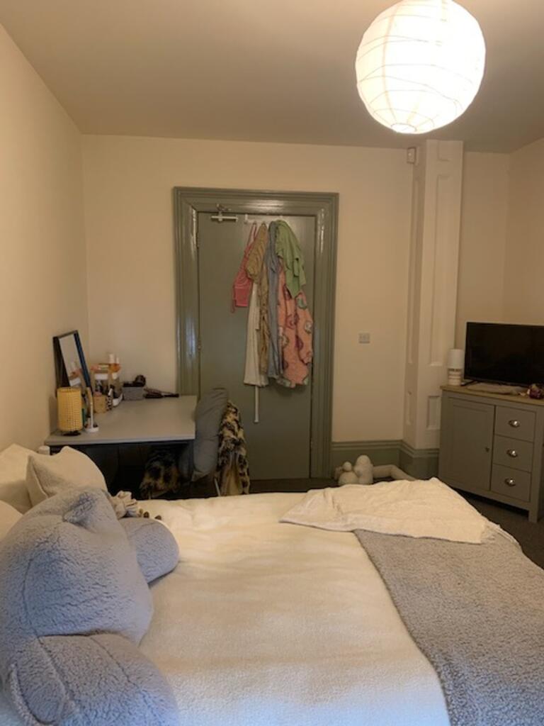 A cozy double bedroom with a comfortable bed an...