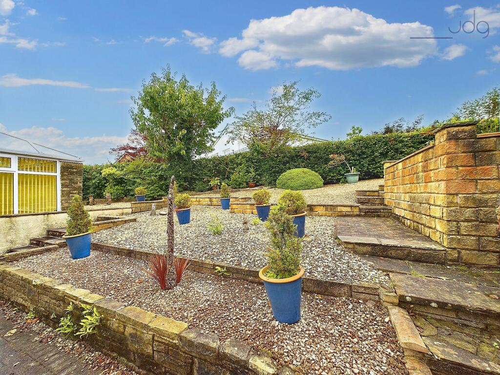 The gardens wrap around the home