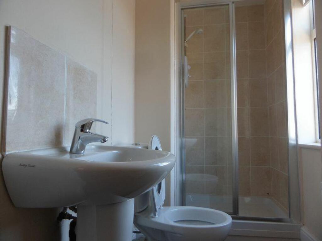 A clean and modern bathroom featuring a shower ...