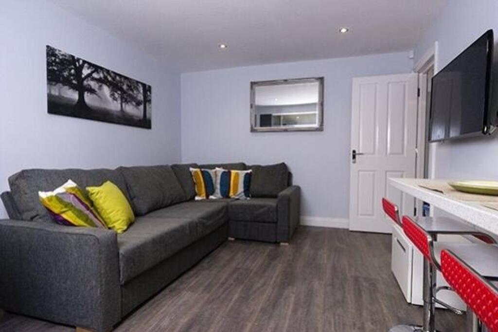 A bright and inviting living room featuring a c...
