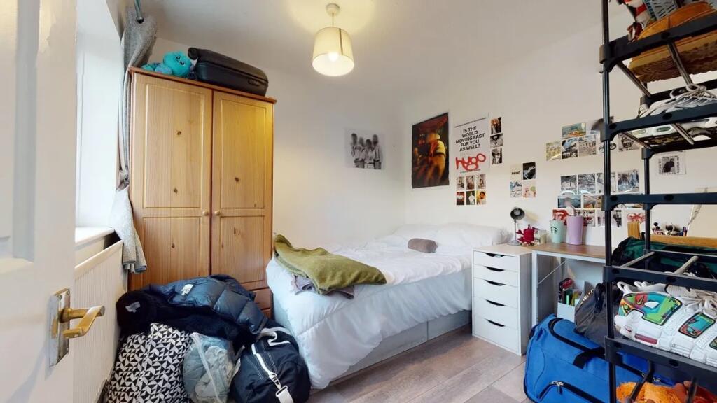 A cozy double bedroom featuring a neatly made b...
