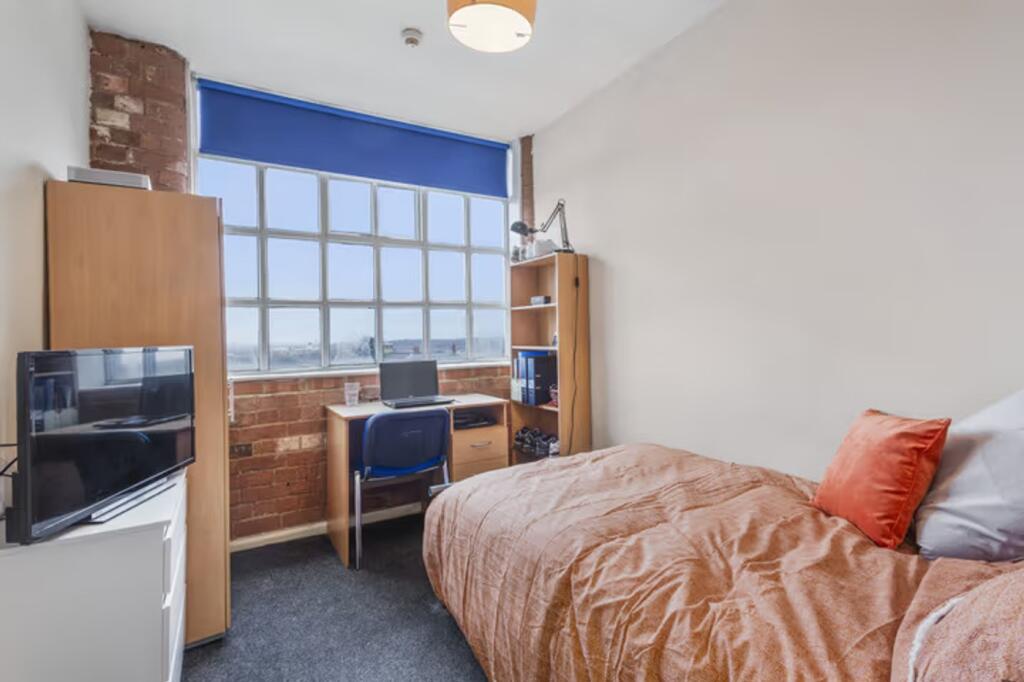 A bright and inviting double bedroom featuring ...