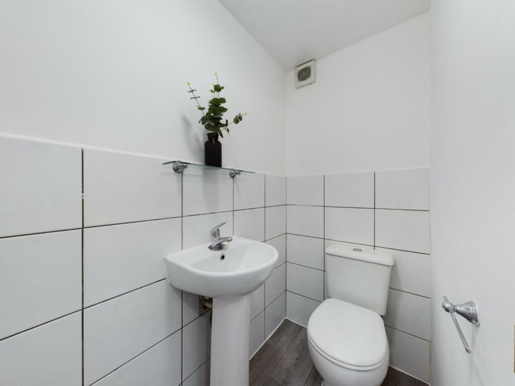 A clean and minimalist single toilet with moder...