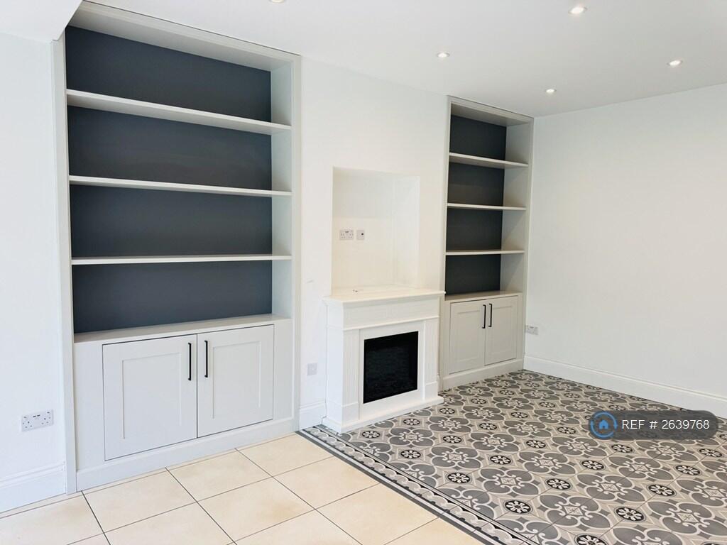 Family Room Has An Electric Fire And Bookshelves