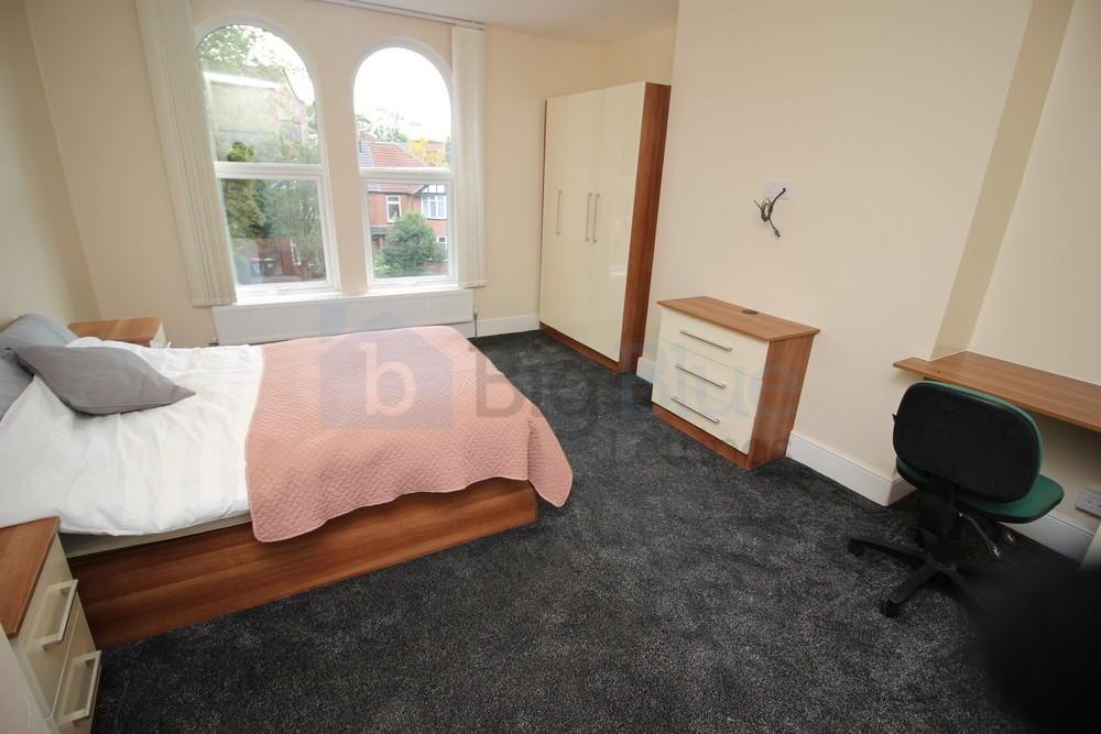 Spacious and bright master bedroom featuring a ...