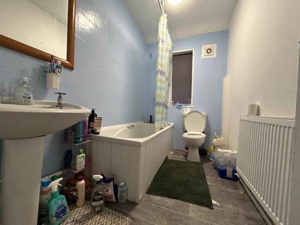 A bright and functional bathroom featuring a ba...