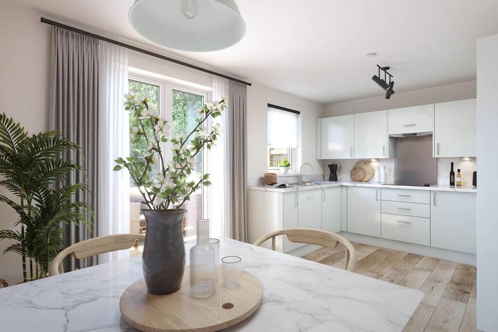 Bright open-plan kitchen-diner with modern appliances and double doors leading to the garden, perfe