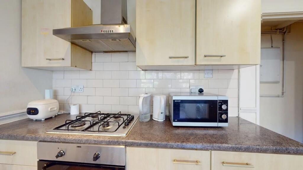 A tidy and functional kitchen featuring a gas h...