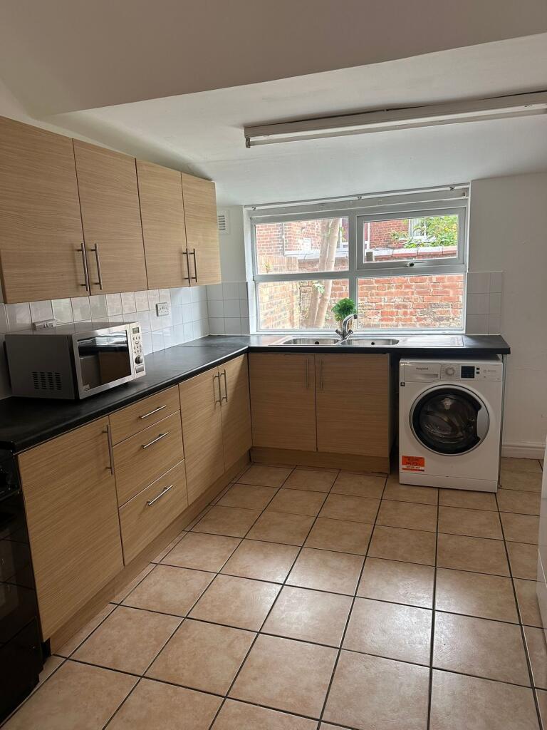 Bright and tidy kitchen featuring ample natural...