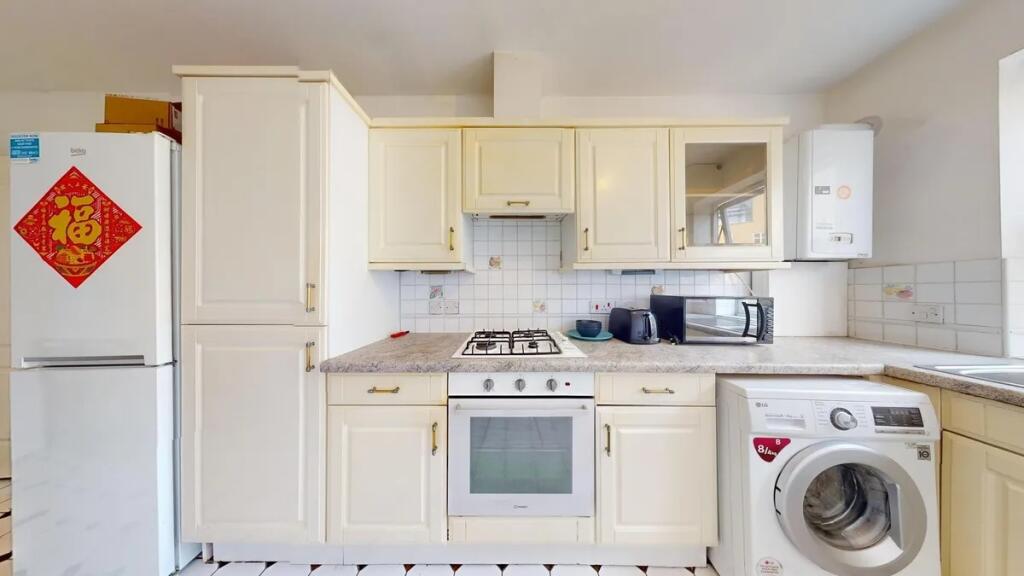 Bright and clean kitchen featuring ample cabine...