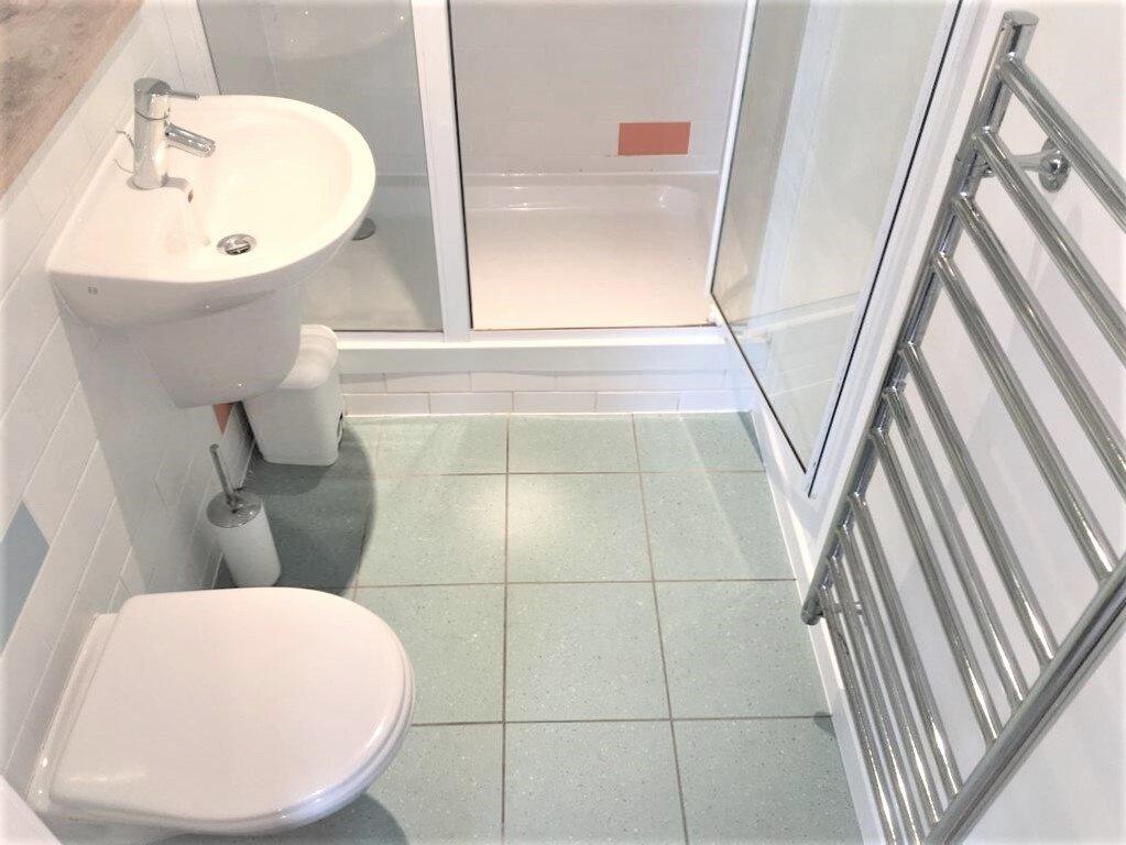 A modern bathroom suite featuring a clean white...