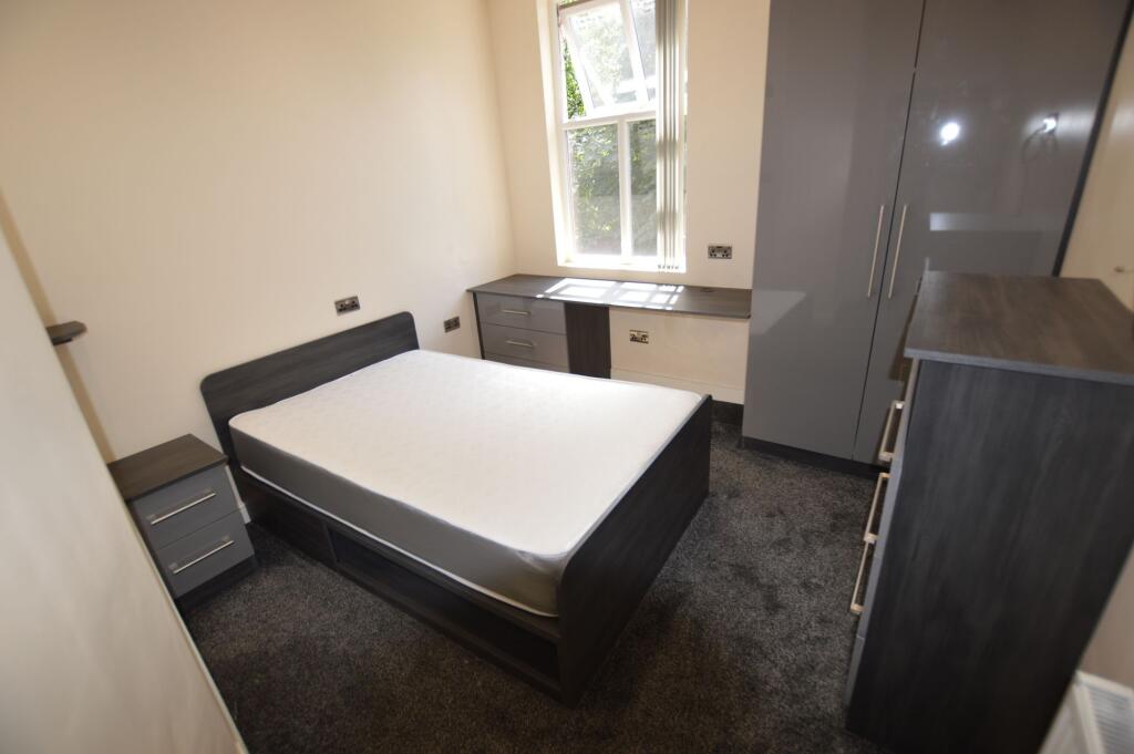 A tidy and well-maintained bedroom featuring mo...