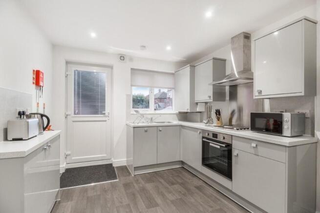Bright and modern kitchen featuring sleek grey ...