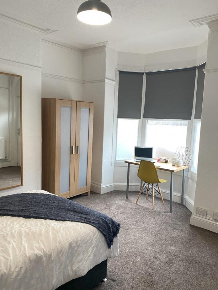A bright and cozy double bedroom featuring a co...