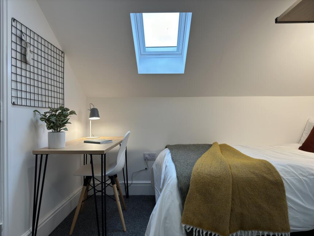 A bright and inviting double bedroom featuring ...