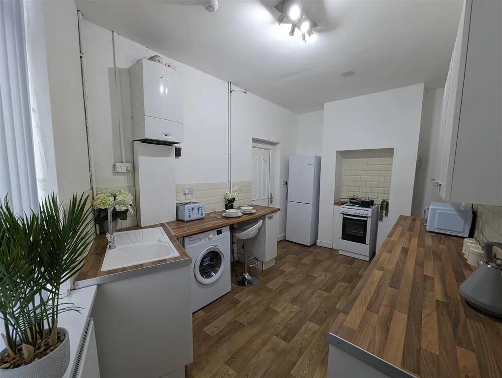A bright and clean kitchen with modern applianc...